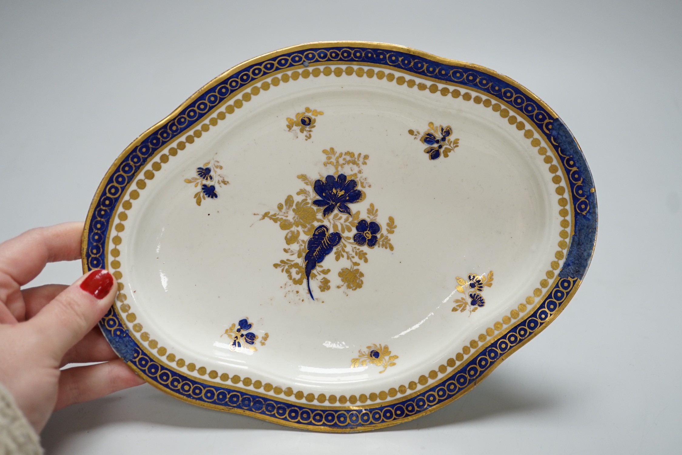 An 18th century Caughley tureen cover and stand with blue and gilt decoration, stand mis-fired to border, S mark to stand and base, stand 23cms wide